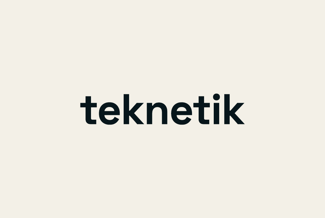 The front of the teknetik business card: the wordmark on paper.